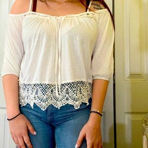 White loose fit off the shoulder blouse with lace detailing.